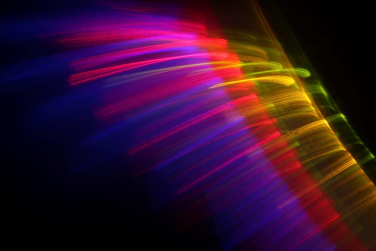 Image created by MCarscience for Printoptical Artist profile showing a curve of colorful light exposed by 3D printed optics