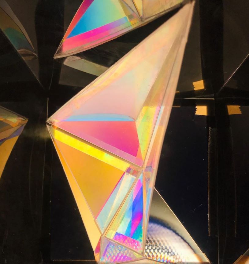 Image by Lilian van Daal showing infinite reflections through internal stress through triangular material arrangement in a plastic box